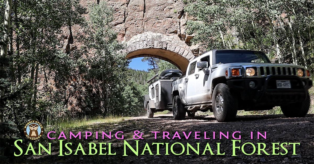 Ike and Poe in front of the Apishapa Arch in San Isabel National Forest, Colorado