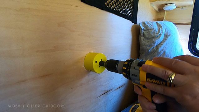 hole saw drilling begins inside the camper cabin